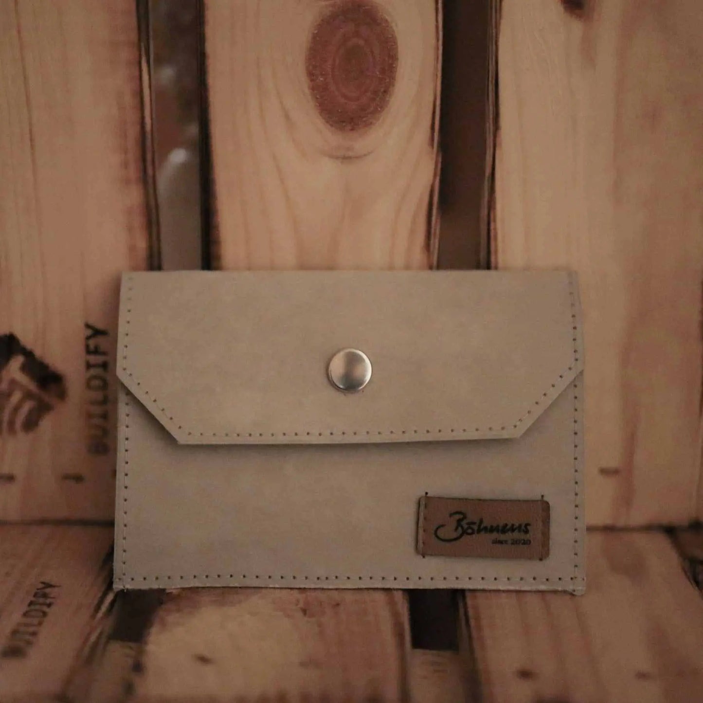 Kartenetui "stein" aus paperTEX vor Holzhintergrund, 100% vegan und PVC-frei.