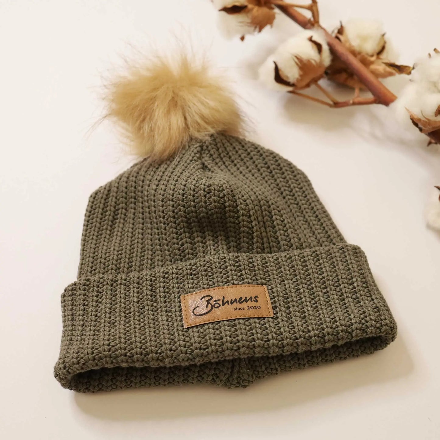 Kids' chunky knit hat in army green with pom-pom, perfect for cold weather.