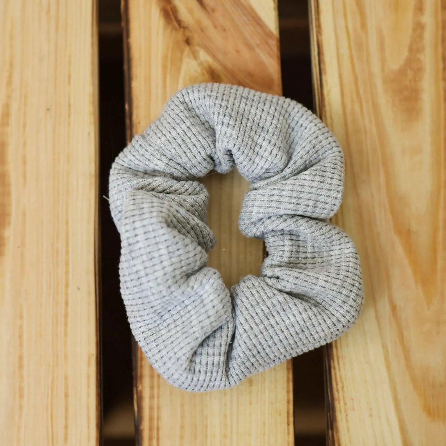 Gray waffle jersey scrunchie as hair band or wrist accessory.