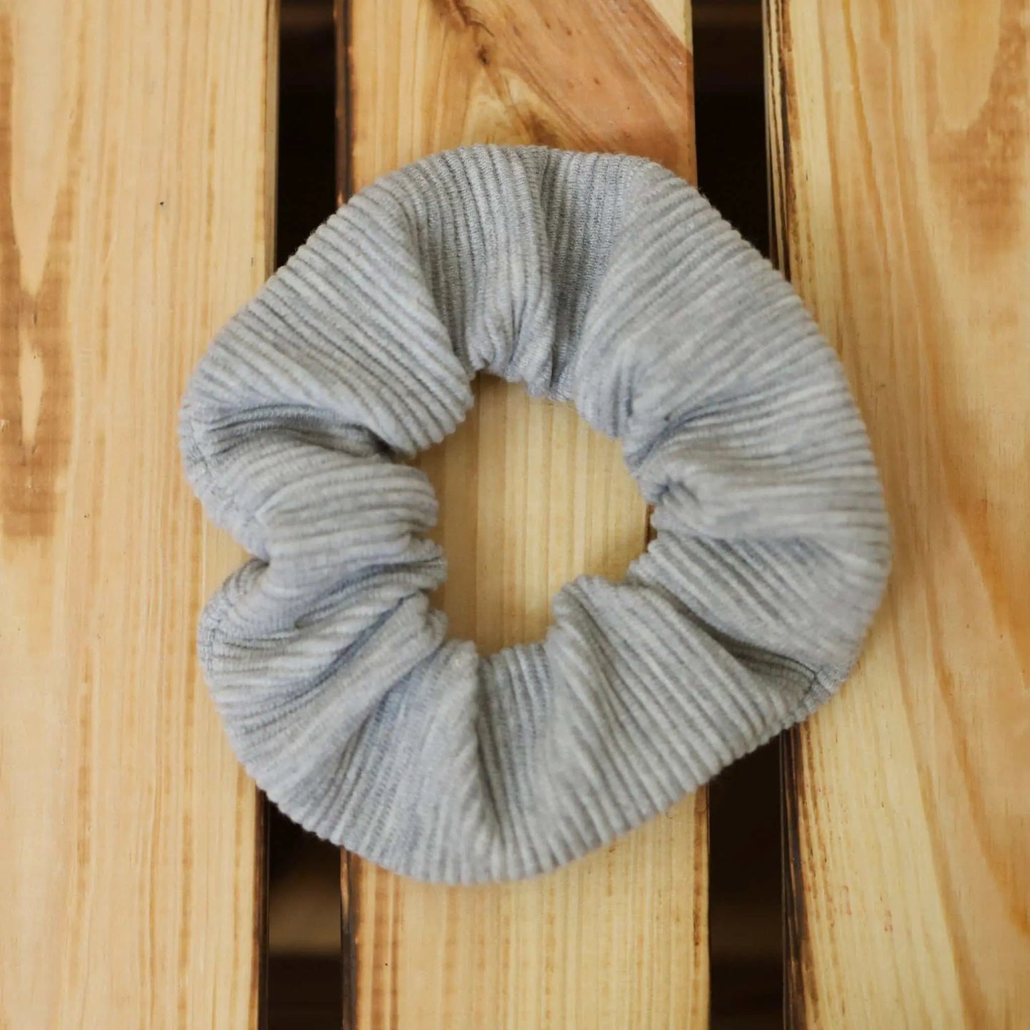 Gray scrunchie made from fabric scraps, versatile hair tie and accessory.