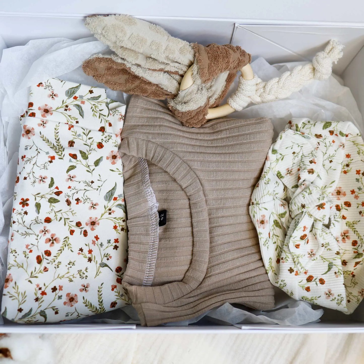 Baby Geschenkbox Blumenmeer with floral-patterned pullover, leggings, turban hat, and teething ring in a gift box.