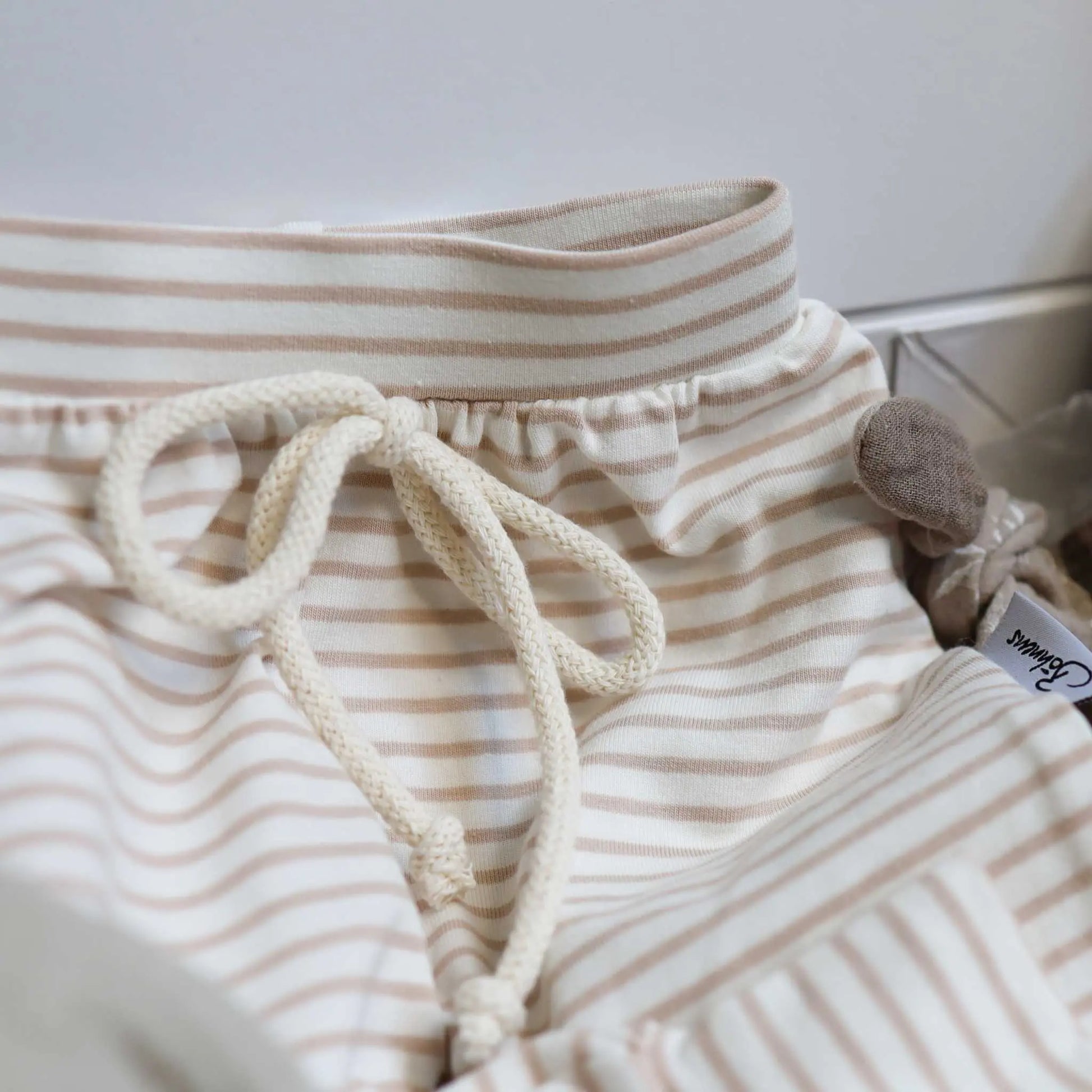 Baby Geschenkbox Hase taupe with harem pants, teething ring, and cuddly rabbit.